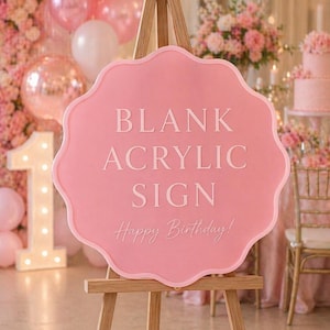 May include: A scalloped-edge pink acrylic sign mounted on a wooden tripod easel. The sign features the white text BLANK ACRYLIC SIGN in a bold, sans-serif font, with the script text Happy Birthday! positioned directly underneath in white.