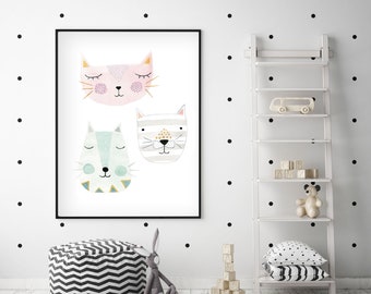 May include: A framed wall art print featuring three stylized cat faces in soft pastel colors, including a pink cat, a light blue cat, and a grey striped cat, all with closed eyes and simple line-drawn facial features.