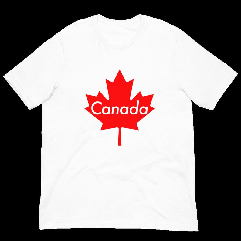 K&ouml;nnte beinhalten: Wei&szlig;es T-Shirt mit einem roten Ahornblatt und dem Wort "Canada" darauf gedruckt.
