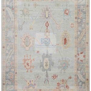 May include: A light blue rug with a traditional Persian design. The rug has a central medallion with intricate details and a border with repeating patterns. The rug is made of wool and is in good condition.
