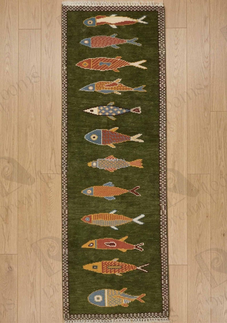 May include: A long, rectangular green rug with a repeating pattern of colorful fish. The fish are in various colors, including red, blue, yellow, and orange, and are arranged in a vertical row. The rug has a decorative border.
