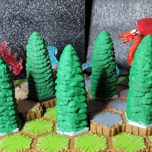 May include: Five green miniature plastic trees on a brown and green hexagonal game board. The trees are all the same size and shape, and they are arranged in a circle around a red plastic dragon.
