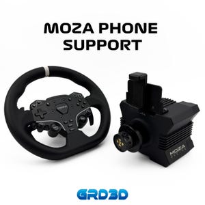 May include: Black MOZA racing steering wheel and phone support. The steering wheel has a black grip with a white stripe at the top. The phone support is black and has the text "MOZA PHONE SUPPORT" above it.
