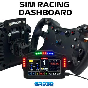 May include: A black racing wheel with a digital dashboard display. The dashboard shows a timer, lap times, and other racing data. The text "GRD3D" is visible on the dashboard and the racing wheel.