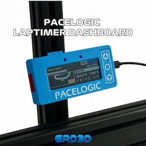 May include: A blue Pacelogic laptimer dashboard device with a digital screen displaying track data, weather, and lap information. The unit features three navigation buttons on the right side and is mounted on a black frame. The text Pacelogic is printed on the front.