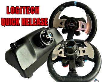 May include: A Logitech quick release steering wheel adapter with a black base and a silver and black steering wheel. The adapter has a blue button and the steering wheel has a blue stripe.