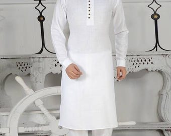 May include: A white long-sleeved kurta with a mandarin collar and a row of black buttons. The kurta is paired with white pants and black sandals.