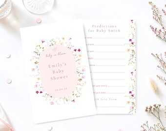 May include: Two white rectangular baby shower cards with a floral border of small pink, yellow, and green wildflowers. The left card features a pink oval with the text "baby in bloom", "Emily's Baby Shower", and "20.09.26". The right card has "Predictions for Baby Smith" and lines for guest entries.