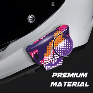 May include: A close-up of a communication device attached to a white surface. The device has a purple base with a colourful pattern of pink, orange, and white dots. The text "PREMIUM MATERIAL" is visible.