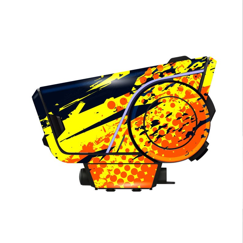 May include: A futuristic device with a black, yellow, and orange color scheme. The design features a combination of geometric shapes and abstract patterns, including splatters and circles. The device has a sleek, modern appearance.