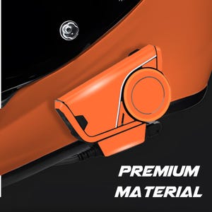 May include: Close-up of an orange device with a circular component and black accents. The text "PREMIUM MATERIAL" is displayed in white. The device is set against a black background.