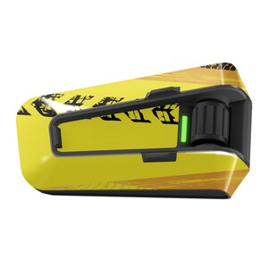 May include: A yellow and black motorcycle intercom with a green light and a black knob. The intercom has a tire tread pattern on the side.