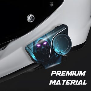 May include: A black and blue device with a graphic of a hooded figure with glowing purple eyes. The device is attached to a white surface, with the words "PREMIUM MATERIAL" in white text.