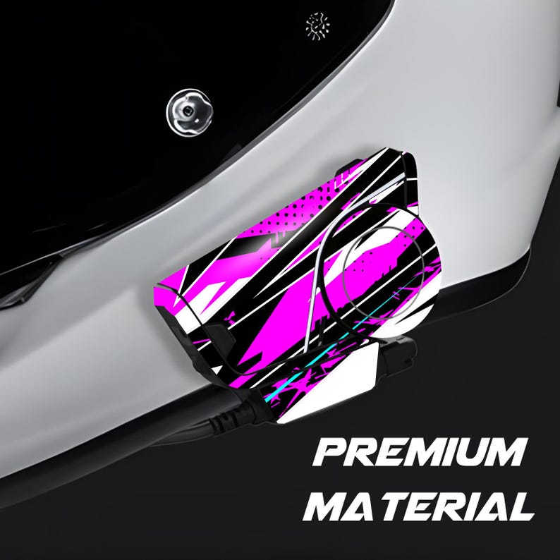 May include: A close-up of a white and black object with a vibrant pink and black abstract design. The text "PREMIUM MATERIAL" is displayed in white. The object is connected to a black cable.