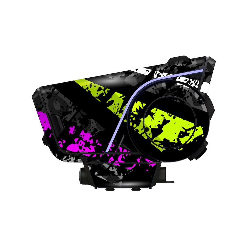 May include: A black and gray device with a neon green and magenta splatter design. The device has a curved shape with a circular component on the right side and a rectangular base. A thin, light purple line accents the design.