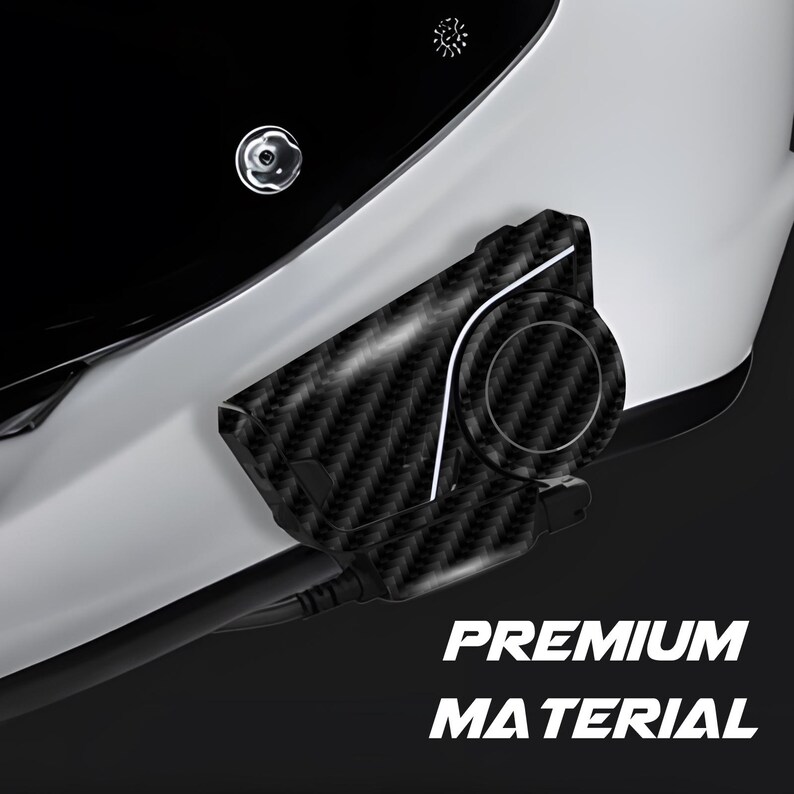 May include: Close-up of a white motorcycle helmet with a black visor. A black carbon fiber communication device is attached to the side. The text "PREMIUM MATERIAL" is displayed in white.