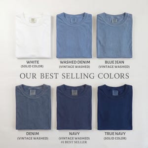 May include: Six short-sleeved crew neck t-shirts arranged in two rows. Colors include white, washed denim, blue jean, denim, navy, and true navy. Text reads: OUR BEST SELLING COLORS, WHITE, WASHED DENIM, BLUE JEAN, DENIM, NAVY, and TRUE NAVY.