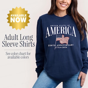 May include: A navy blue long-sleeve shirt featuring the white text UNITED STATES OF AMERICA, a graphic of the American flag, and the text 250TH ANNIVERSARY 1776-2026. The image includes text stating AVAILABLE NOW, Adult Long Sleeve Shirts.