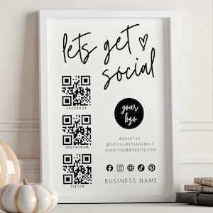 Puede incluir: Impresi&oacute;n enmarcada en blanco con el texto "Let's get social" en fuente de letra cursiva negra. La impresi&oacute;n tambi&eacute;n incluye un s&iacute;mbolo de coraz&oacute;n, un c&iacute;rculo con el texto "your logo" en negro, y tres c&oacute;digos QR etiquetados como "Facebook", "Instagram", y "TikTok". La impresi&oacute;n tambi&eacute;n incluye el texto "#HASHTAG @SOCIALMEDIAHANDLE WWW.YOURWEBSITE.COM" y "BUSINESS NAME" en negro.