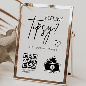 May include: A white sign with black text and graphics in a silver frame. The sign reads "Feeling Tipsy? Tip Your Bartender". It includes a QR code and a cash icon.