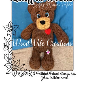 May include: A brown knitted teddy bear with a tan snout and a red heart. The bear has blue eyes and is wearing a small pin. The text "Faithful Friend" and "Wood Wife Creations" are displayed on the image.