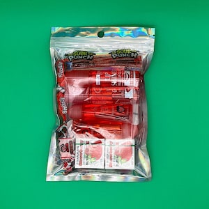 May include: A clear plastic bag containing a selection of lip glosses and sweets. The lip glosses are red and have a strawberry fragrance. The sweets are red and white and feature the words "Sour Punch" on the packaging.