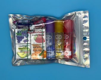 Paquete de brillo de labios y dulces Paquete con temática afrutada. sin vapores
