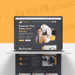 May include: A laptop displaying a website with the text "Empower Your Team, Drive Success." The website features a professional design with a dark gray and yellow color scheme, and includes images of business professionals.