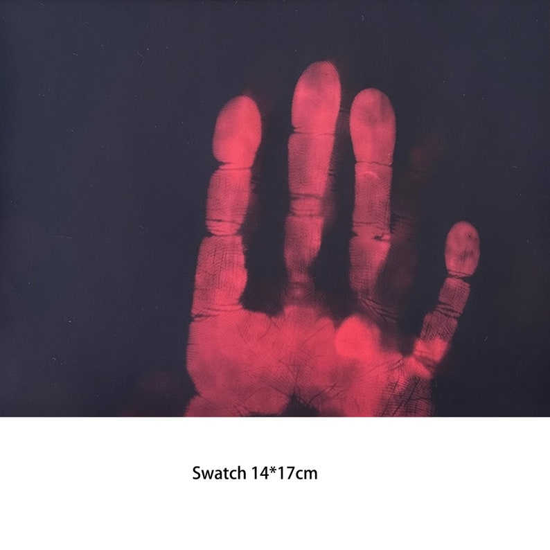 May include: A red handprint on a black background. The handprint is a thermal image, showing the heat of the hand. The image is 14 inches by 17 inches.