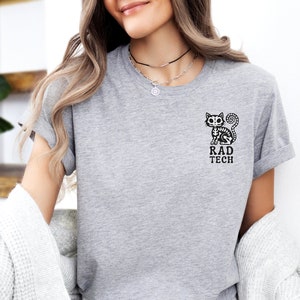 May include: Gray t-shirt with a black skeleton cat graphic and the text "RAD TECH".