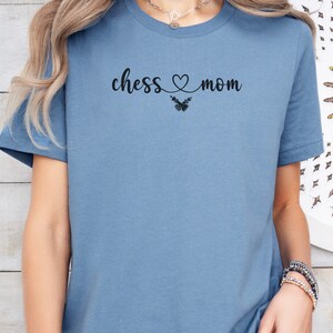 May include: A blue t-shirt with the text "chess ♥ mom" printed on the front.
