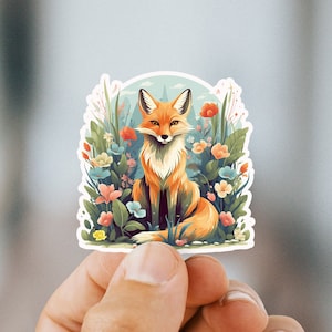 May include: A sticker featuring a red fox sitting in a field of colorful flowers. The fox has a white chest and a bushy tail. The flowers are a variety of colors, including pink, purple, yellow, and blue.