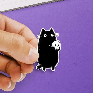 Black Cat Sticker – Cute Cartoon Kitty Holding Skull, Waterproof Vinyl Decal for Laptops, Water Bottles & Journals