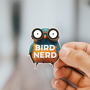 May include: A blue and orange bird wearing goggles with the text "BIRD NERD" on its chest.