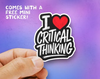 May include: A black and white sticker with the text "I ❤️ CRITICAL THINKING" and a red heart. The sticker is held in a hand against a purple background. The text "COMES WITH A FREE MINI STICKER!" is also visible.
