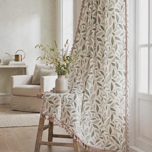 May include: A curtain featuring a botanical pattern of green and muted brown leaves on a cream background, finished with a delicate pink tassel trim along the edge. The text GrowHomeDesign is visible in the bottom right corner of the image.