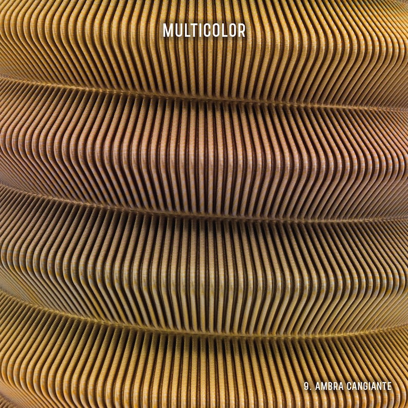 May include: Close-up of a textured, layered design with a repeating pattern of vertical lines. The image features a gradient of colors, from light brown to gold. The word "MULTICOLOR" is at the top, and "9. AMBRA CANGIANTE" is at the bottom.