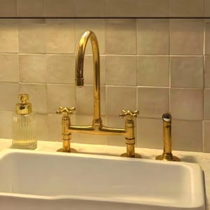 unlaquered brass kitchen faucet with long legs, and Side Sprayer, bridge faucet, luxury unlacquered brass faucet with cross handle