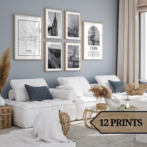 May include: A set of 12 black and white prints depicting various architectural and cityscapes of Cork, Ireland. The prints are displayed on a wall above a white sofa with cushions and a coffee table.
