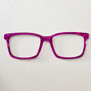 May include: A pair of magenta-coloured eyeglasses with a rectangular frame.