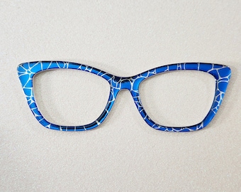 May include: Blue cat-eye glasses with a white crackle pattern. The glasses have a silver bridge and silver arms.