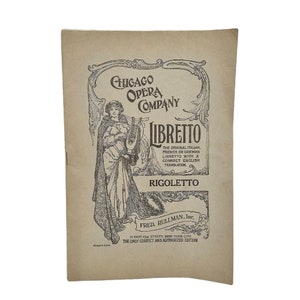 May include: A vintage tan-colored booklet with a black and white illustration of a woman holding a lyre. The text on the cover reads "Chicago Opera Company Libretto The Original Italian, French or German Libretto with a Correct English Translation Rigoletto Fred. Pullman, Inc. 17 East 42nd Street, New York City The Only Correct and Authorized Edition".