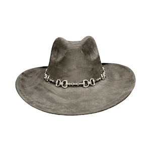 May include: A charcoal gray fedora hat featuring a wide brim and a pinched crown. The base of the crown is encircled by a silver-toned metal chain link band that mimics the appearance of a horse bit, adding a metallic accent to the hat.