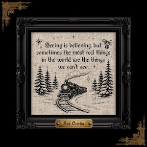 May include: A framed cross-stitch embroidery on light beige fabric featuring a black steam train traveling through a snowy forest. The text reads: Seeing is believing, but sometimes the most real things in the world are the things we can't see.