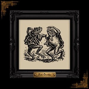 May include: A framed black and white cross-stitch art piece featuring two anthropomorphic frogs dancing. The artwork is set against a beige background and framed in a decorative black frame. The text "Ars Opirika" is on a small plaque at the bottom.