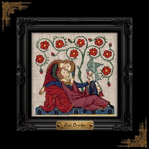 May include: A framed cross-stitch embroidery depicting two figures in medieval-style clothing under a stylized tree with red flowers and a blue bird. The figures are reclined on a blue structure. A gold plaque at the bottom reads Ars Onirika.