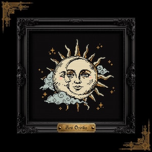 May include: A framed cross-stitch embroidery featuring a sun and moon with human faces, surrounded by stylized clouds and small stars in gold, cream, and light blue on a black background. A gold plaque at the bottom reads the text Ars Onirika.