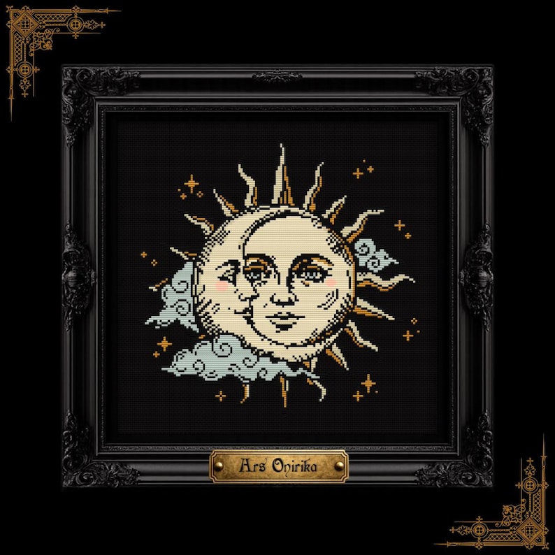 May include: A framed cross-stitch embroidery featuring a sun and moon with human faces, surrounded by stylized clouds and small stars in gold, cream, and light blue on a black background. A gold plaque at the bottom reads the text Ars Onirika.