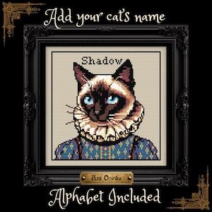 May include: A cross-stitch pattern featuring a Siamese cat wearing a ruffled collar and a blue patterned garment. The text "Add your cat's name" appears at the top, "Shadow" above the cat, and "Alphabet Included" at the bottom of the frame.