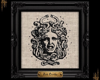 May include: A black cross-stitch embroidery on light beige fabric featuring a Medusa head with snakes for hair, framed in a black ornate frame with a gold plaque at the bottom that reads Ars Onirika, surrounded by small black star accents.